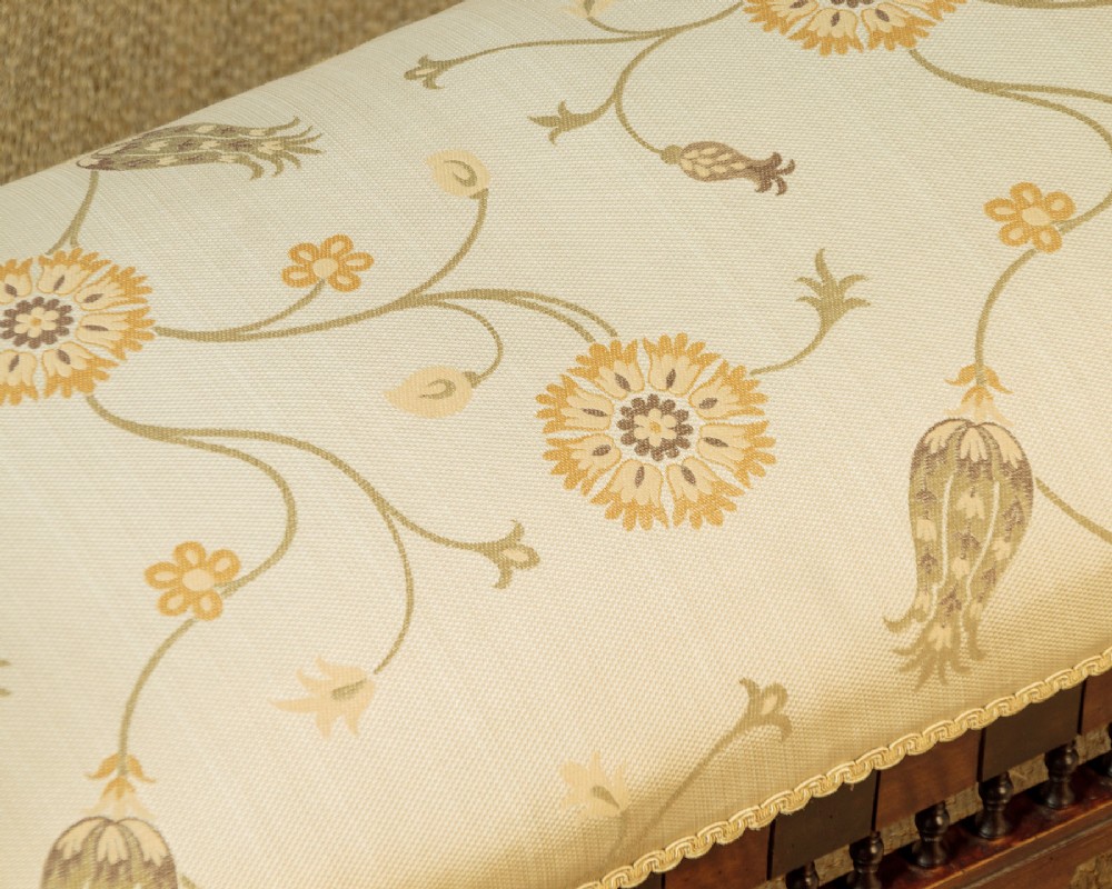 A Syrian dark wood window seat c.1920 with mother-of-pearl geometric inlay, turned lattice side panels, and a cream pattern-upholstered cushion. View VIII