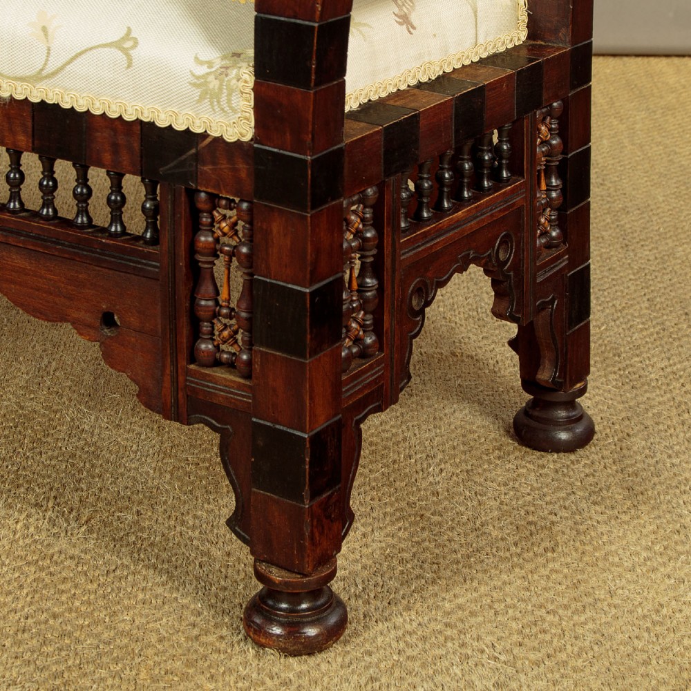 A Syrian dark wood window seat c.1920 with mother-of-pearl geometric inlay, turned lattice side panels, and a cream pattern-upholstered cushion. View IX