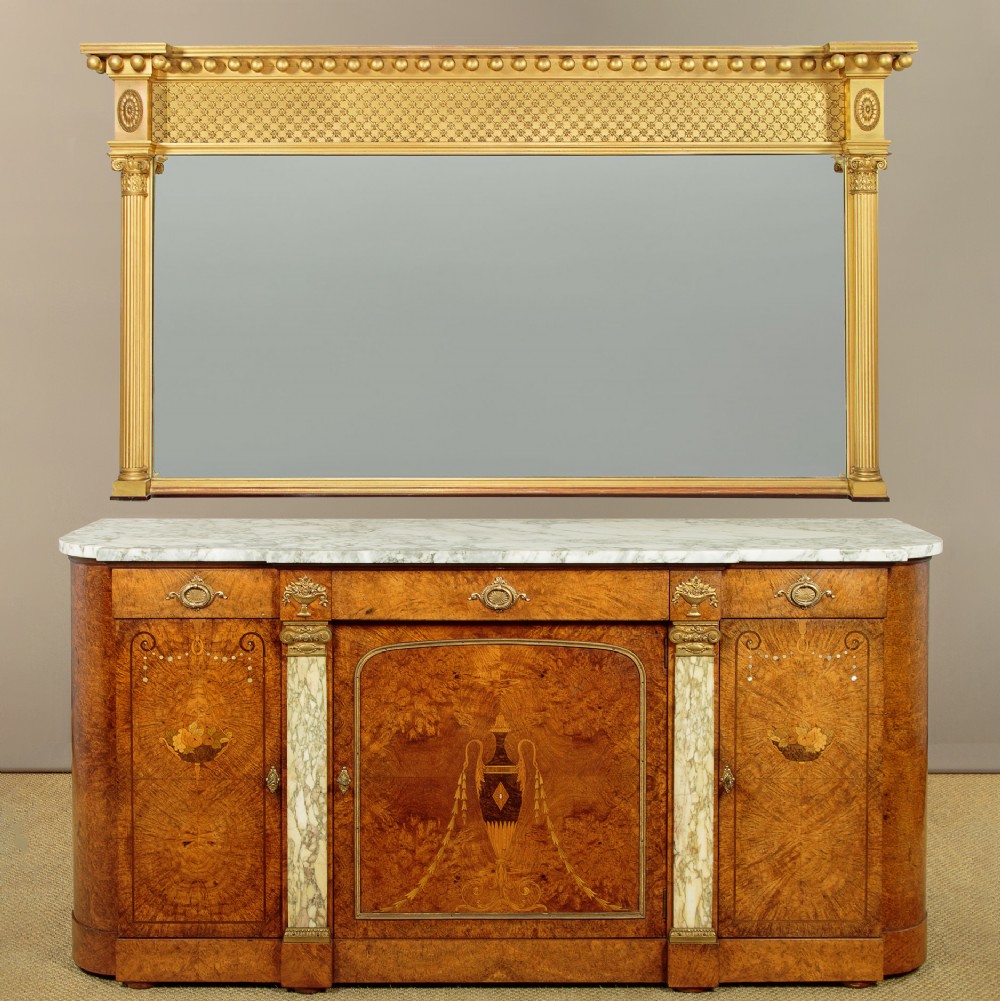 A large rectangular giltwood overmantel mirror featuring a decorated upper frieze with spherical mouldings and fluted side columns. View II
