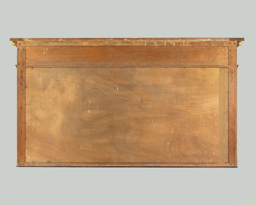A large rectangular giltwood overmantel mirror featuring a decorated upper frieze with spherical mouldings and fluted side columns. View IX