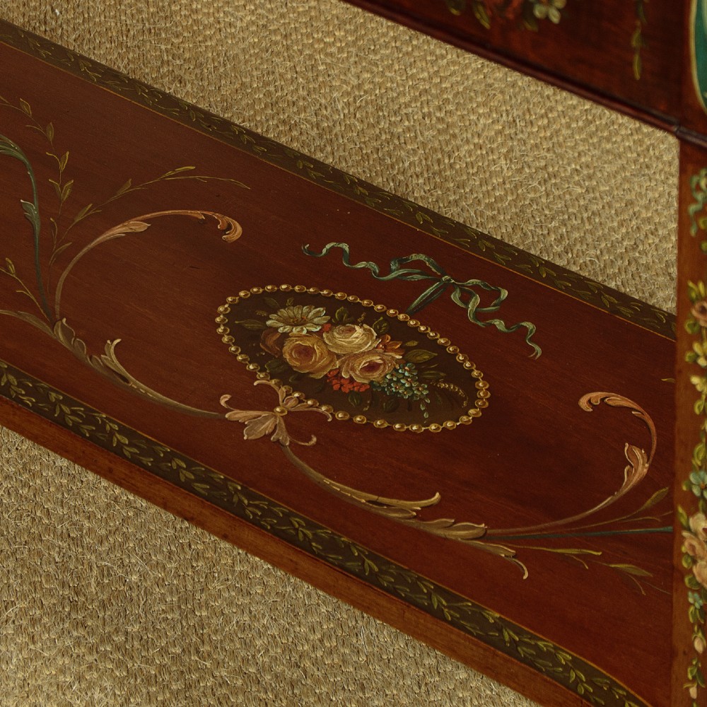A dark mahogany display cabinet featuring hand-painted floral swags, classical urns, glass side panels, twin glazed doors, and tapered legs with an undertier. View XII