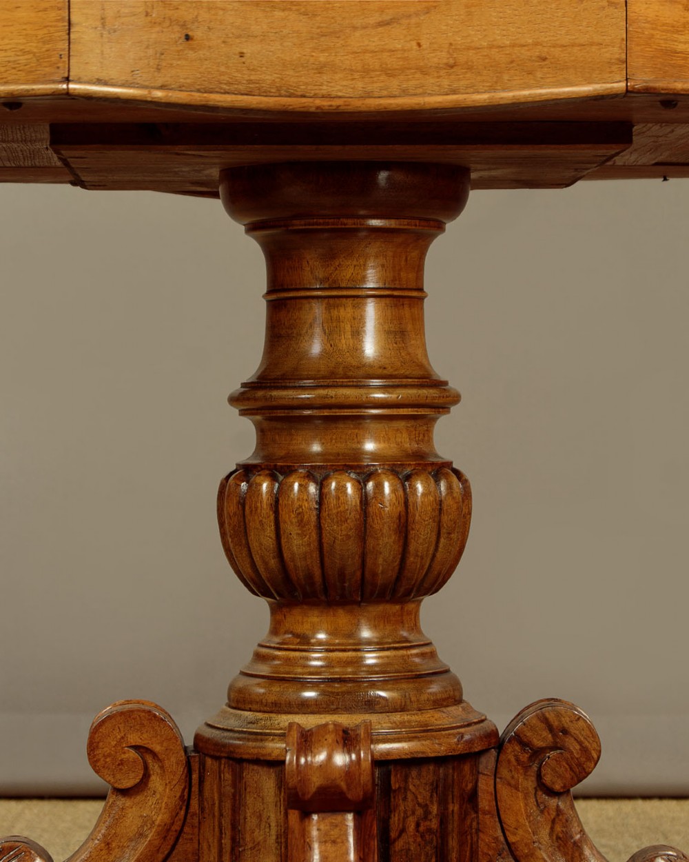 A nineteenth-century Victorian walnut centre table featuring a serpentine white marble top resting on a carved pedestal stem with scrolled tripod legs. View VII