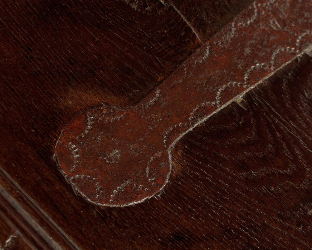 A long dark oak boarded sword chest featuring iron strap hinges and slab end supports. View VIII