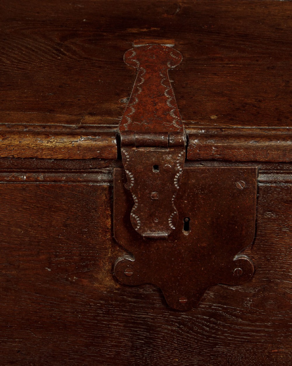 A long dark oak boarded sword chest featuring iron strap hinges and slab end supports. View X