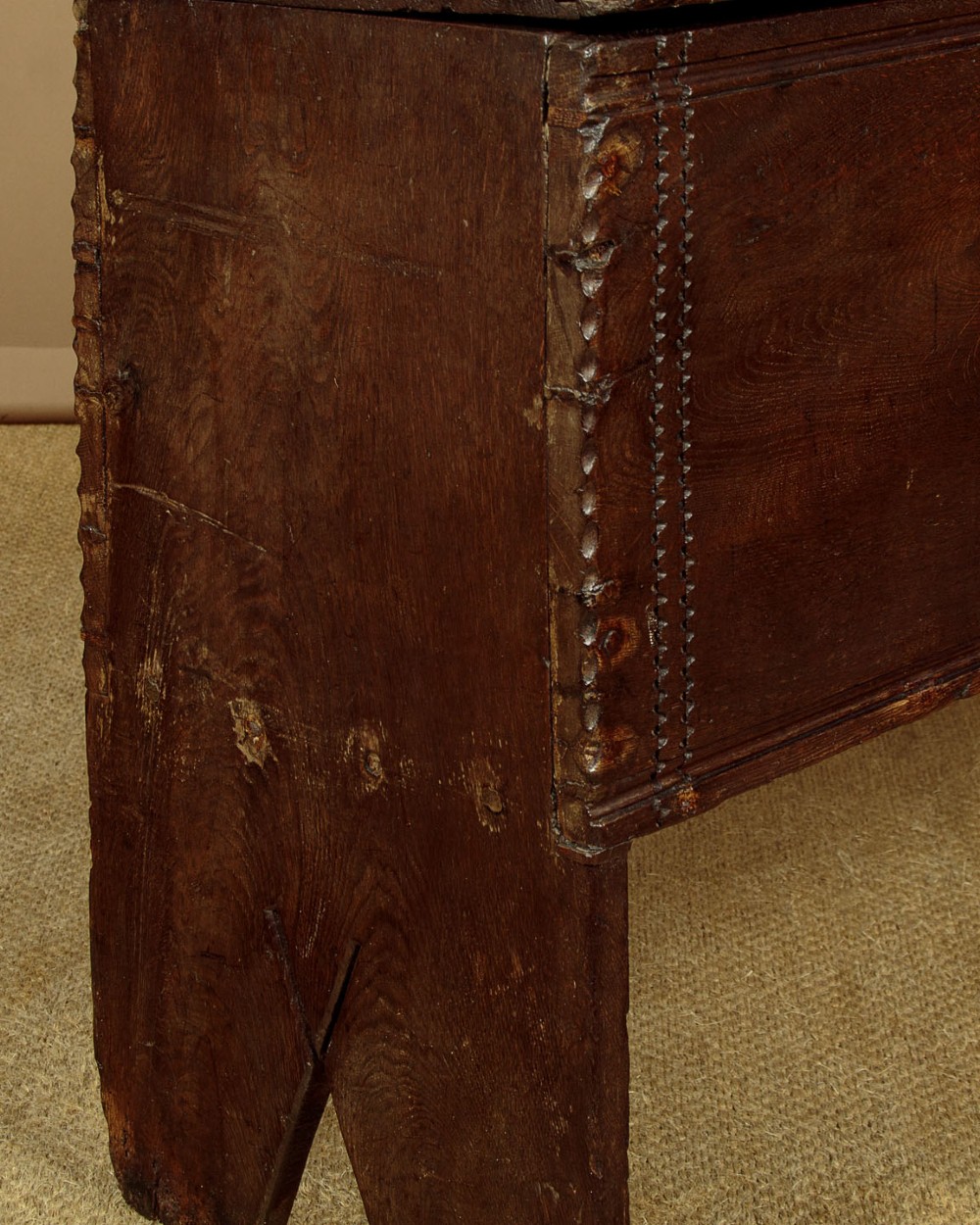 A long dark oak boarded sword chest featuring iron strap hinges and slab end supports. View XI