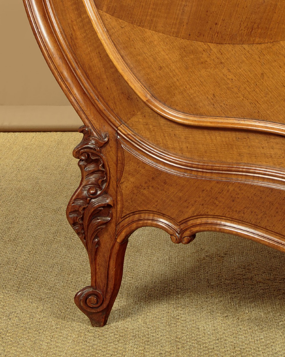 An antique French double bed frame crafted from carved walnut featuring serpentine edges, shell motifs, and book-matched veneered panels on the headboard and footboard. View IX