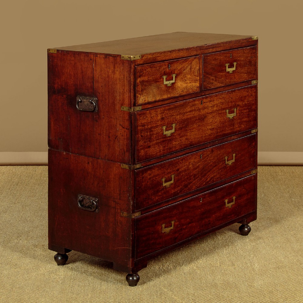 A Victorian mahogany military campaign chest featuring brass corner bindings, flush handles, two short drawers over three long drawers, resting on turned feet. View II