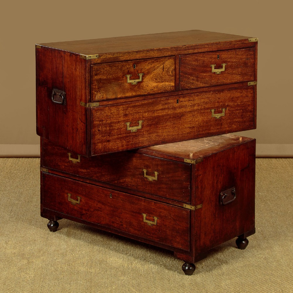 A Victorian mahogany military campaign chest featuring brass corner bindings, flush handles, two short drawers over three long drawers, resting on turned feet. View III