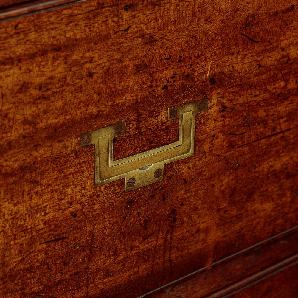 A Victorian mahogany military campaign chest featuring brass corner bindings, flush handles, two short drawers over three long drawers, resting on turned feet. View IX