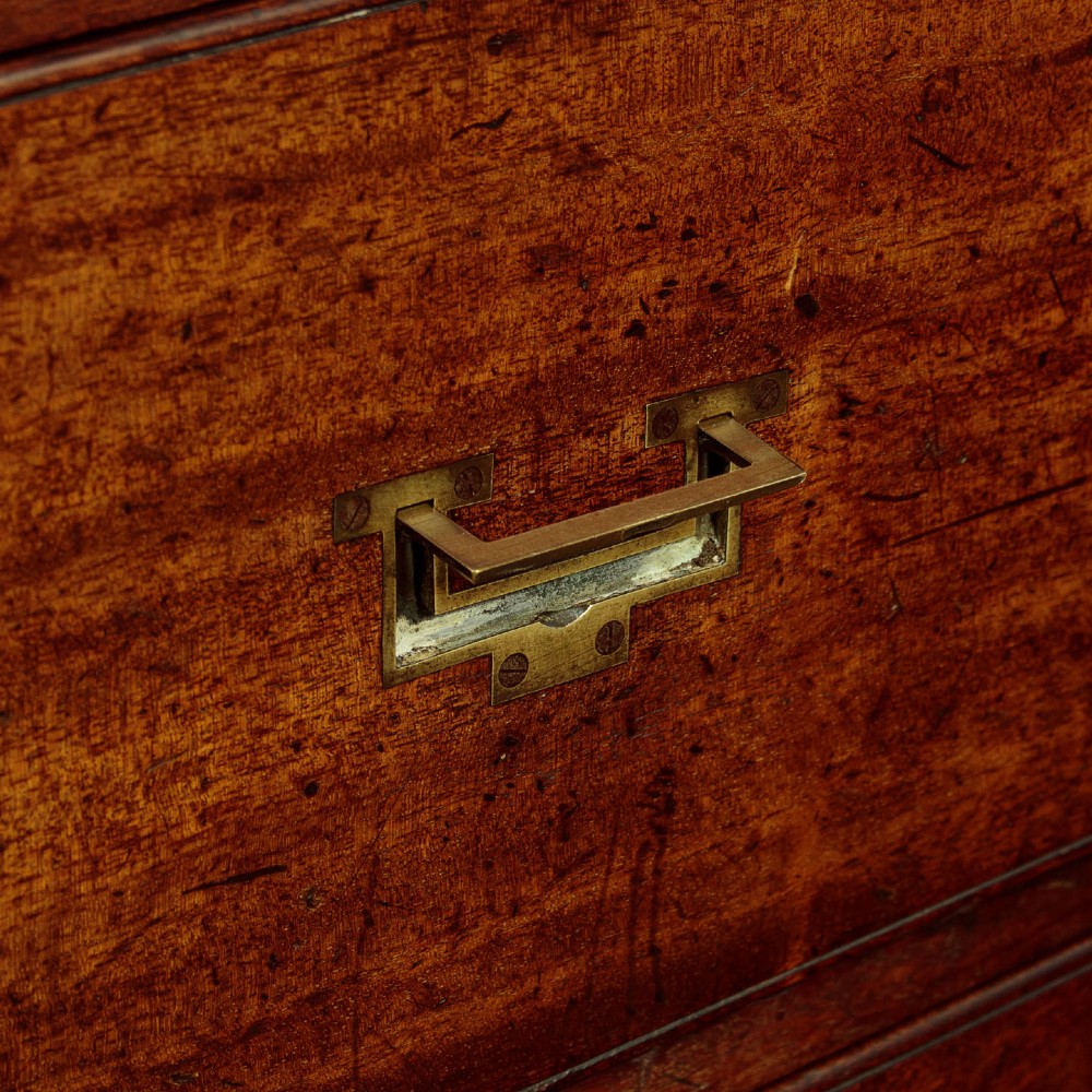 A Victorian mahogany military campaign chest featuring brass corner bindings, flush handles, two short drawers over three long drawers, resting on turned feet. View X
