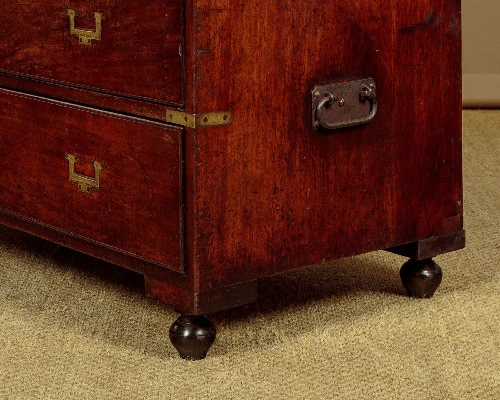 A Victorian mahogany military campaign chest featuring brass corner bindings, flush handles, two short drawers over three long drawers, resting on turned feet. View XI