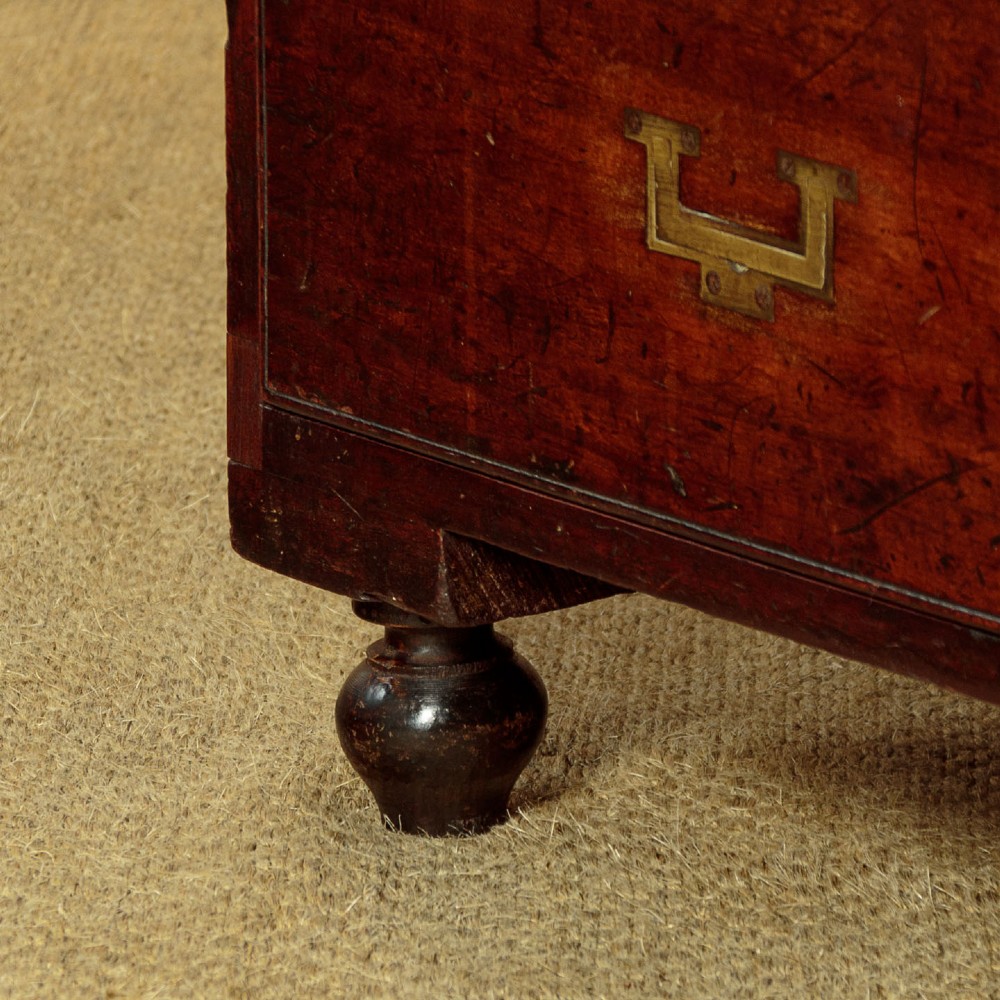 A Victorian mahogany military campaign chest featuring brass corner bindings, flush handles, two short drawers over three long drawers, resting on turned feet. View XII