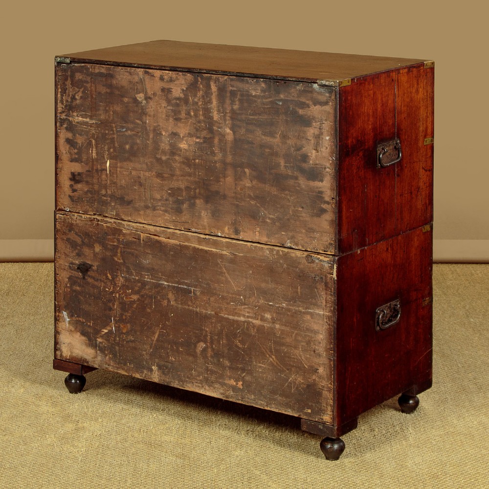 A Victorian mahogany military campaign chest featuring brass corner bindings, flush handles, two short drawers over three long drawers, resting on turned feet. View XIII