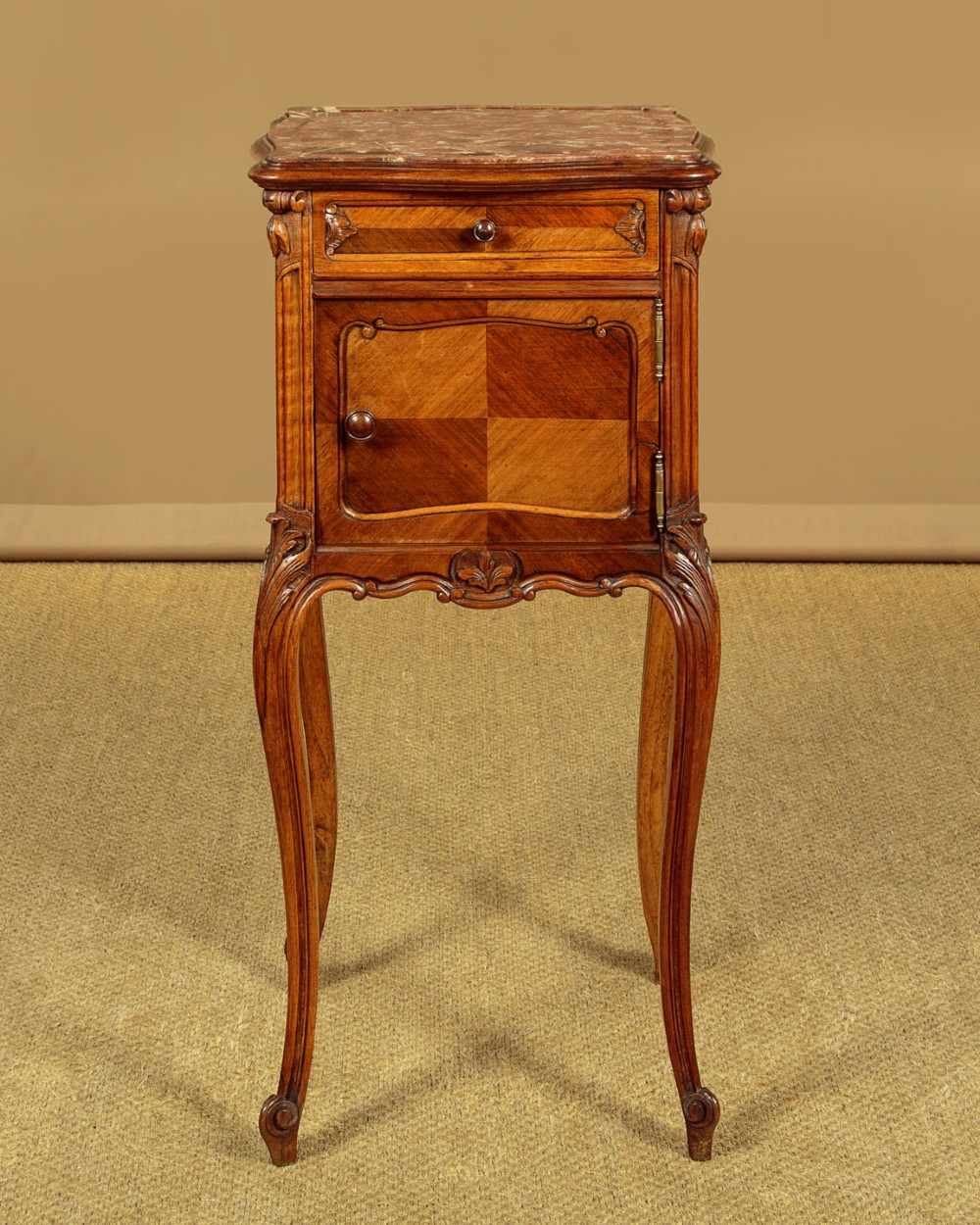 A pair of early twentieth-century walnut bedside cabinets featuring carved cabriole legs and pink variegated marble tops. View II