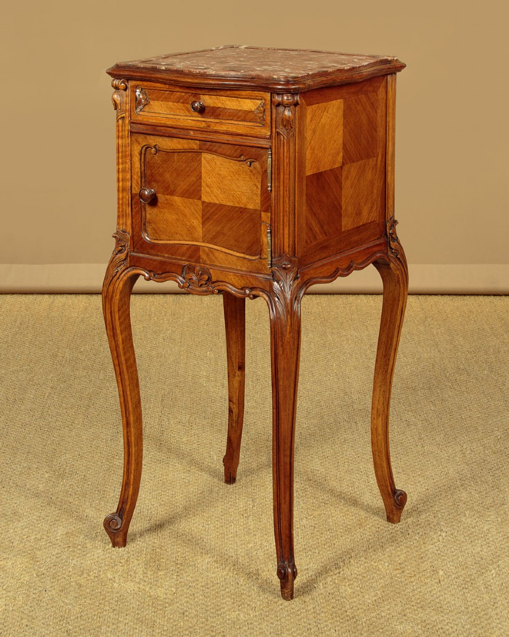 A pair of early twentieth-century walnut bedside cabinets featuring carved cabriole legs and pink variegated marble tops. View III