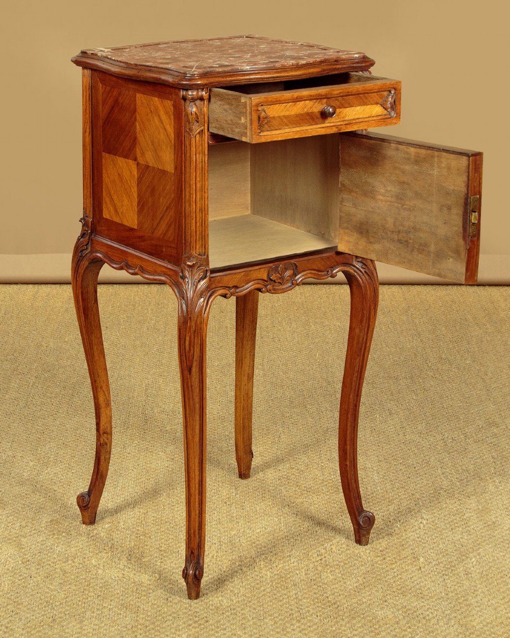 A pair of early twentieth-century walnut bedside cabinets featuring carved cabriole legs and pink variegated marble tops. View IV
