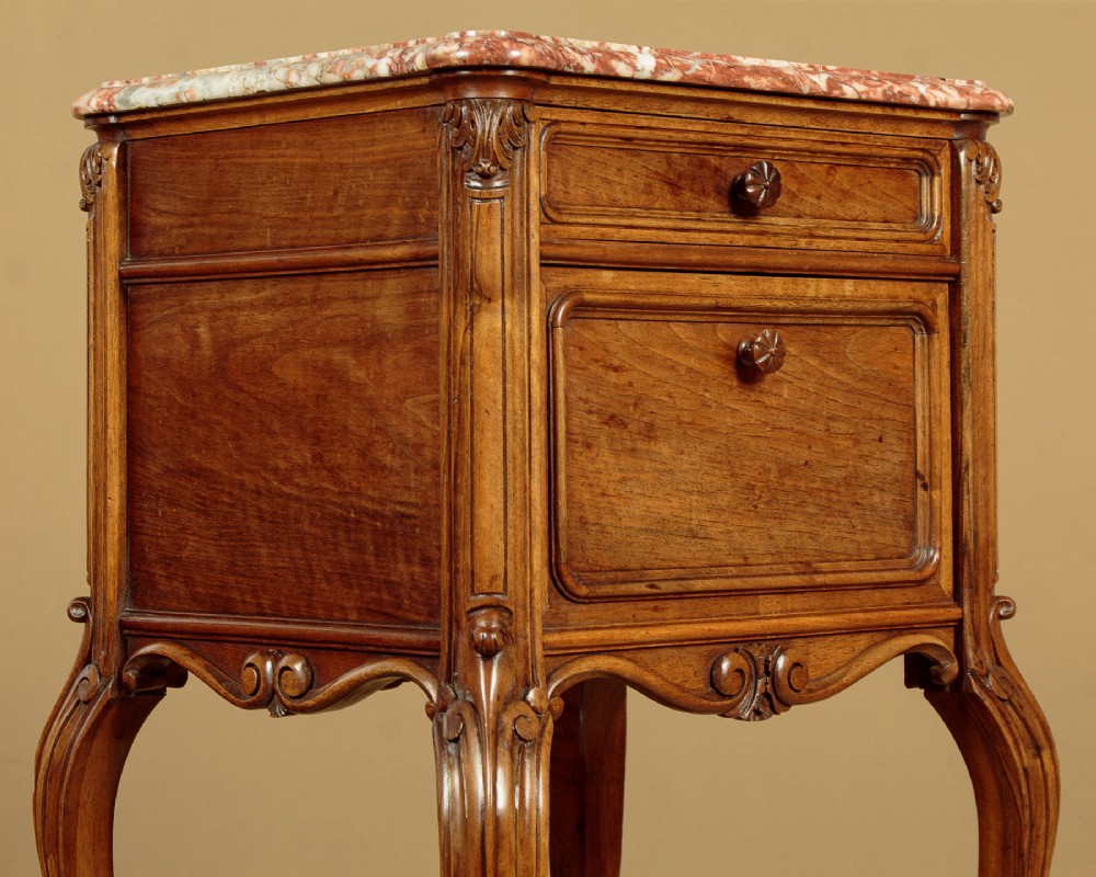 A pair of early twentieth-century walnut bedside cabinets featuring carved cabriole legs and pink variegated marble tops. View XI
