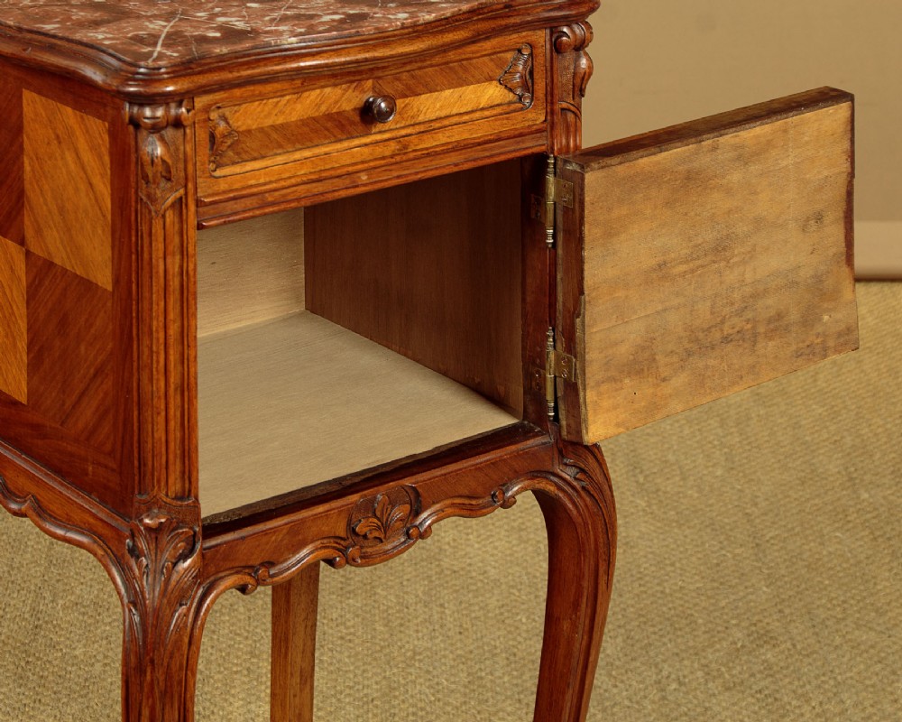A pair of early twentieth-century walnut bedside cabinets featuring carved cabriole legs and pink variegated marble tops. View XII