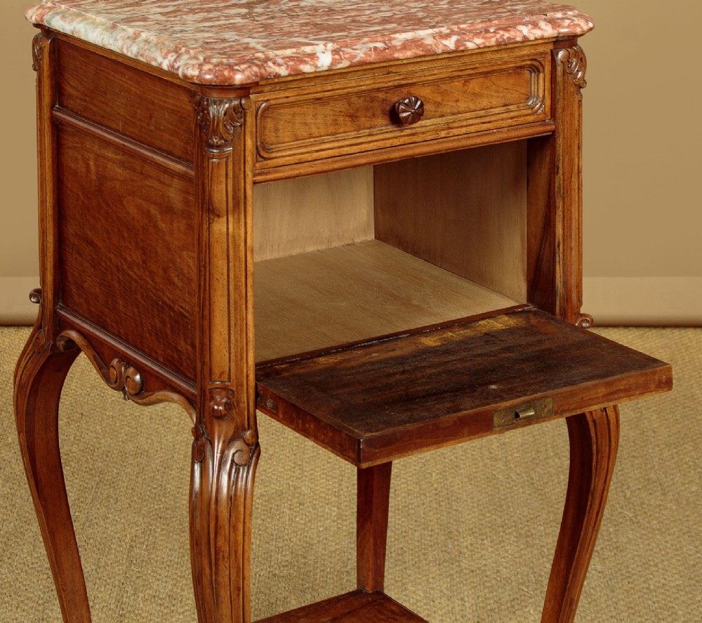 A pair of early twentieth-century walnut bedside cabinets featuring carved cabriole legs and pink variegated marble tops. View XIII