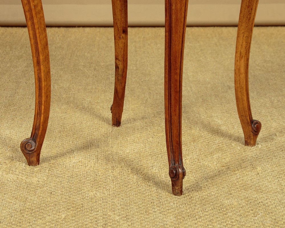 A pair of early twentieth-century walnut bedside cabinets featuring carved cabriole legs and pink variegated marble tops. View XIV