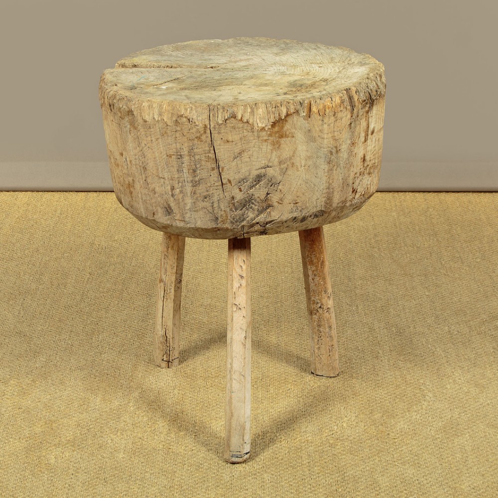 A rustic French provincial elm chopping block featuring a thick cylindrical wood top with three splayed timber legs. View III