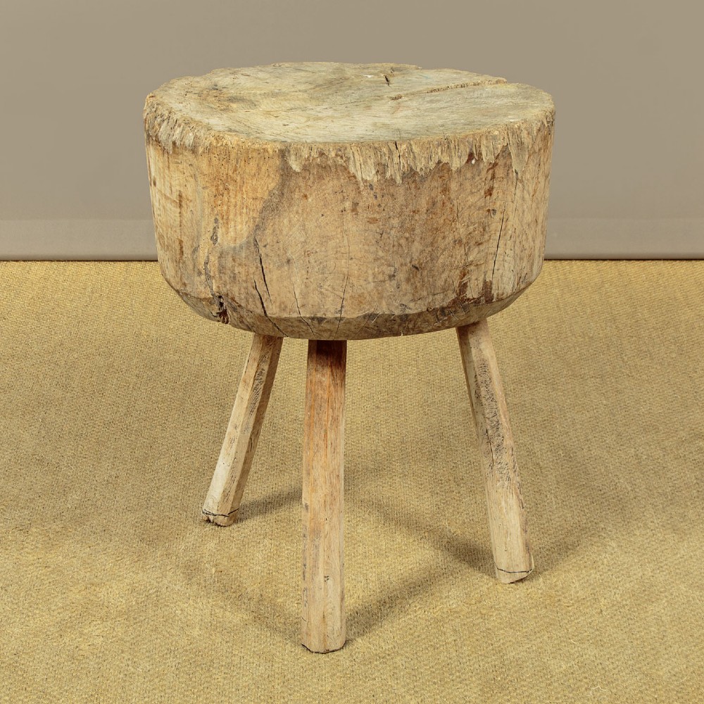 A rustic French provincial elm chopping block featuring a thick cylindrical wood top with three splayed timber legs. View V