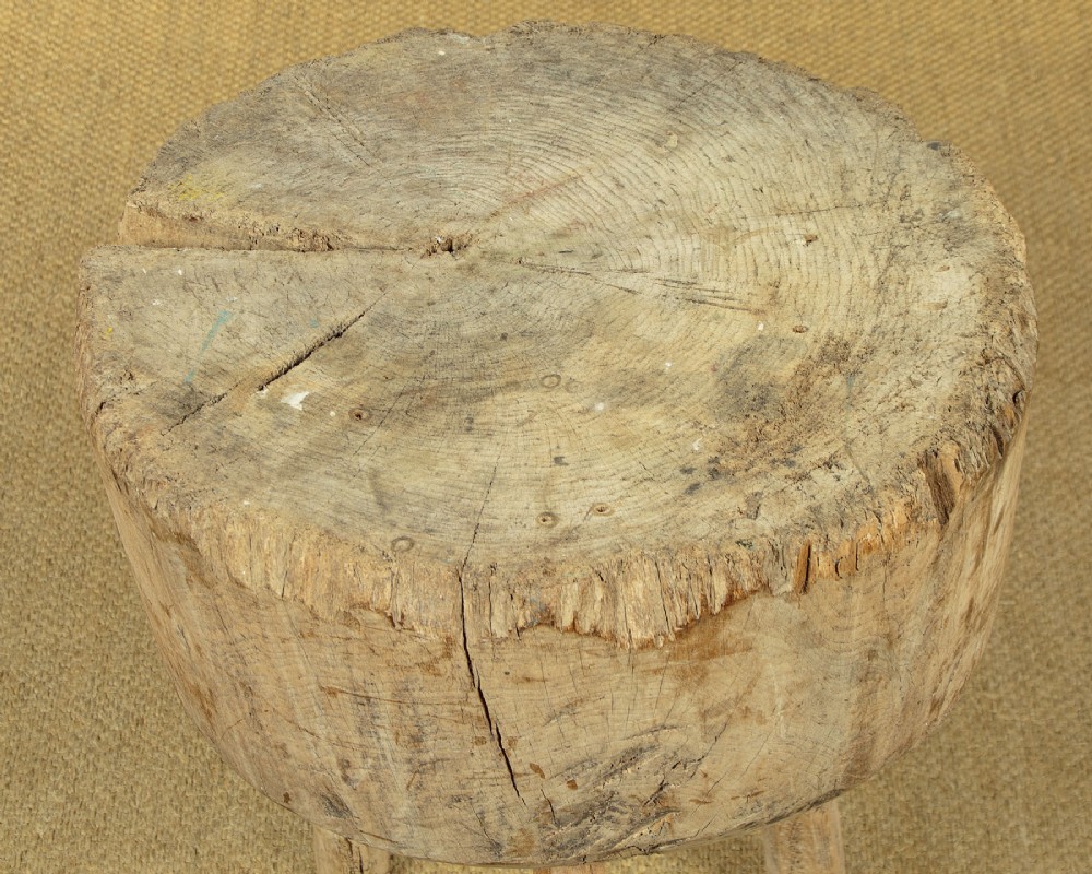A rustic French provincial elm chopping block featuring a thick cylindrical wood top with three splayed timber legs. View VI