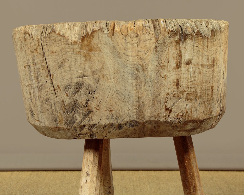 A rustic French provincial elm chopping block featuring a thick cylindrical wood top with three splayed timber legs. View IX