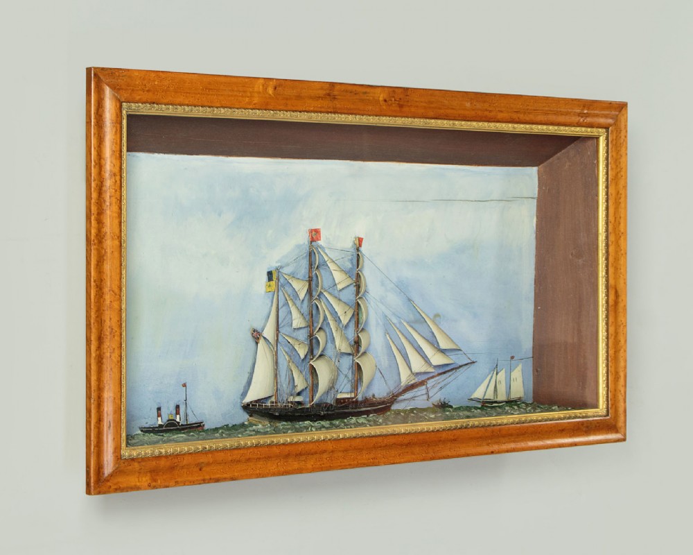 A three-dimensional antique maritime diorama featuring a three-masted sailing ship framed in a deep glazed wooden box with a painted sky and sea background. View II