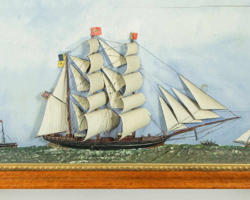 A three-dimensional antique maritime diorama featuring a three-masted sailing ship framed in a deep glazed wooden box with a painted sky and sea background. View IV