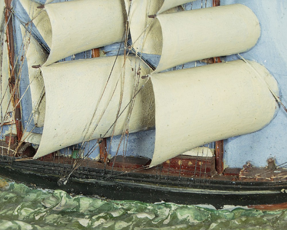 A three-dimensional antique maritime diorama featuring a three-masted sailing ship framed in a deep glazed wooden box with a painted sky and sea background. View VI