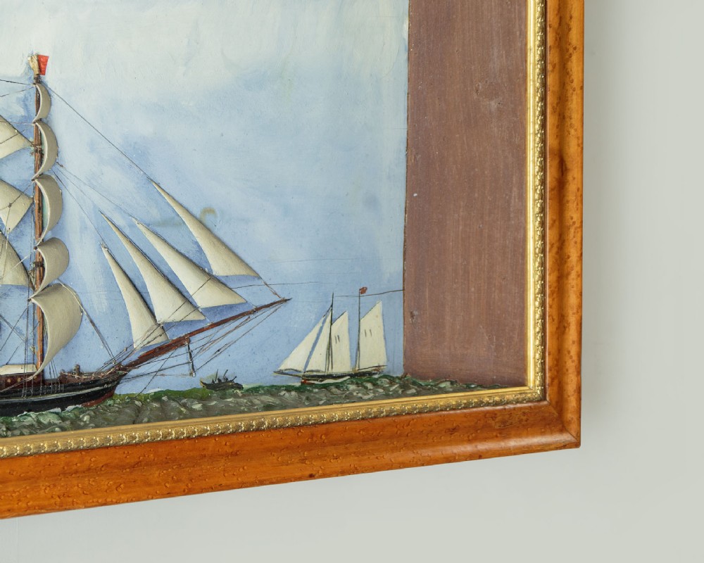 A three-dimensional antique maritime diorama featuring a three-masted sailing ship framed in a deep glazed wooden box with a painted sky and sea background. View XIV