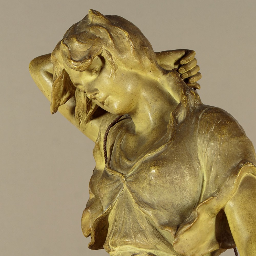 An Art Nouveau terracotta sculpture depicting a draped female water carrier holding two vessels. View VIII