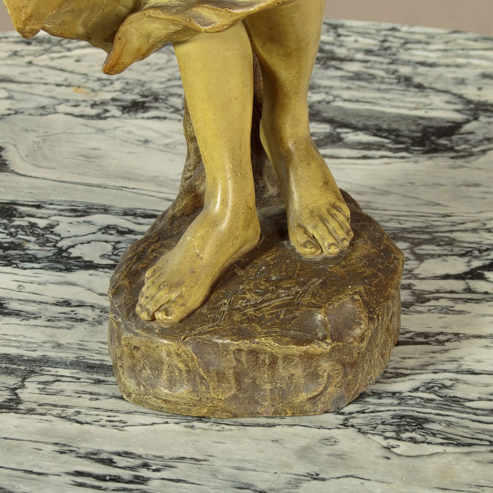 An Art Nouveau terracotta sculpture depicting a draped female water carrier holding two vessels. View XII