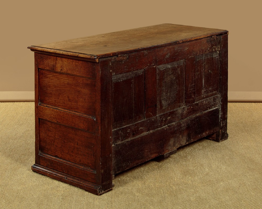 A late eighteenth-century Georgian dark oak mule chest featuring three burr elm inset panels and two lower drawers with brass handles. View XI
