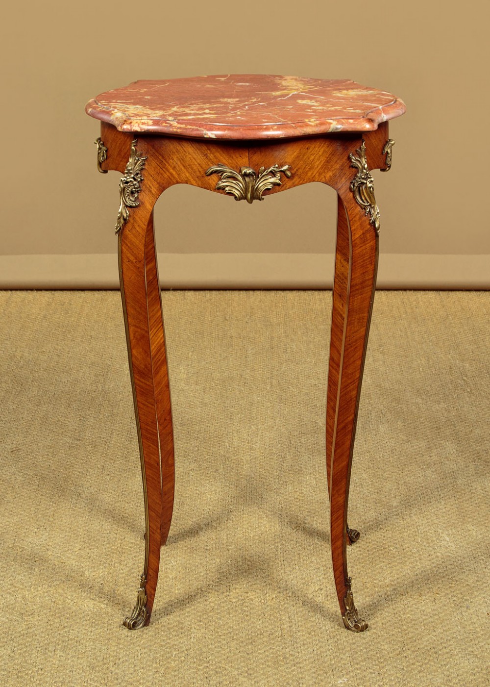 A French Louis XV style wine table with a contoured red marble top, parquetry veneer, metal mounts, and cabriole legs. View IV