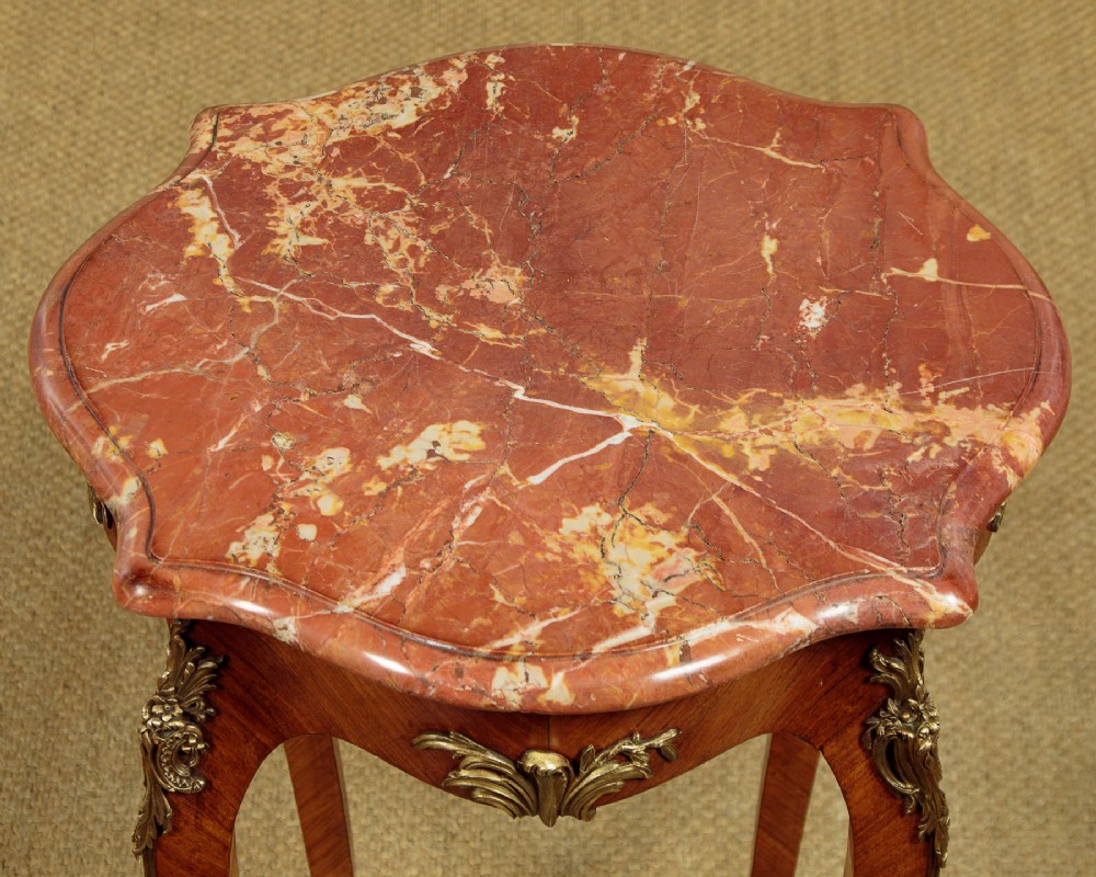 A French Louis XV style wine table with a contoured red marble top, parquetry veneer, metal mounts, and cabriole legs. View V