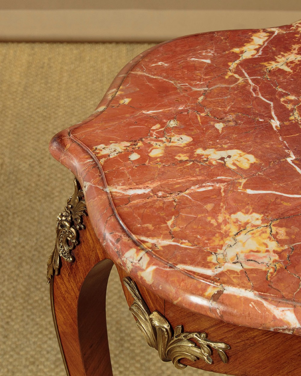 A French Louis XV style wine table with a contoured red marble top, parquetry veneer, metal mounts, and cabriole legs. View VI