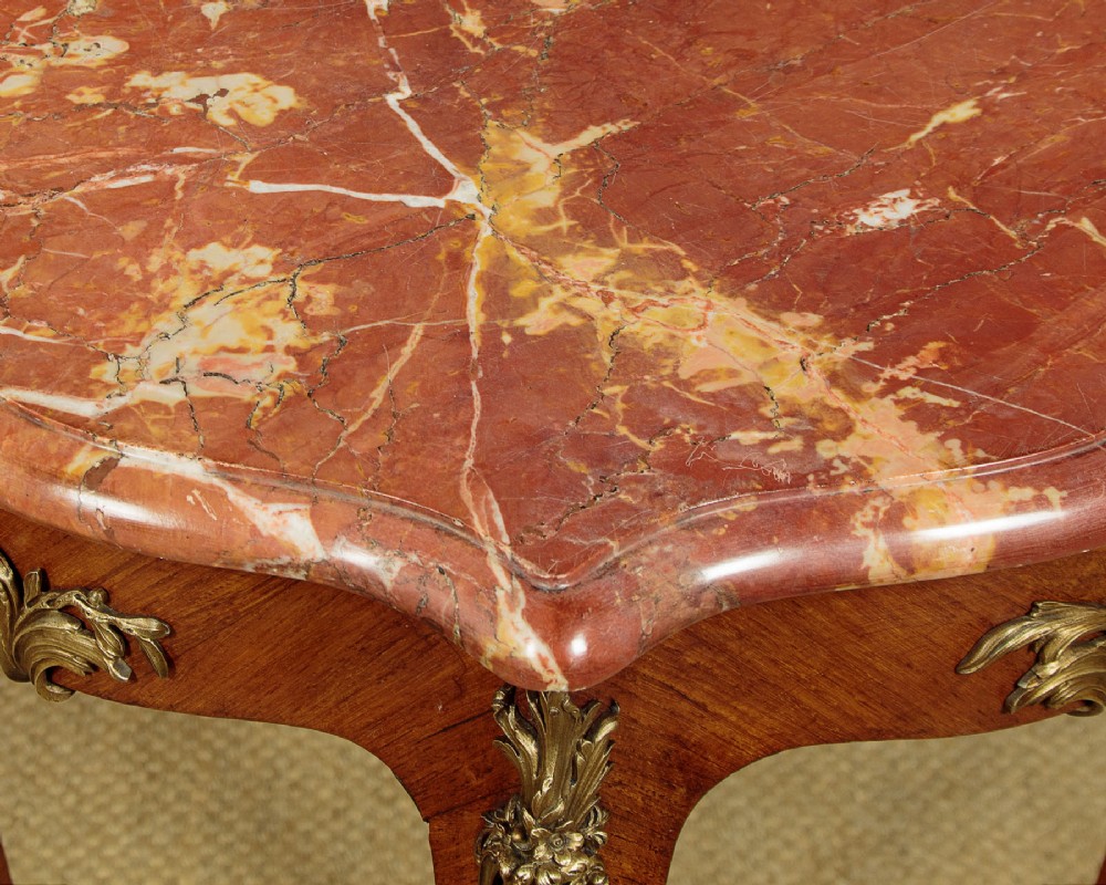 A French Louis XV style wine table with a contoured red marble top, parquetry veneer, metal mounts, and cabriole legs. View VII
