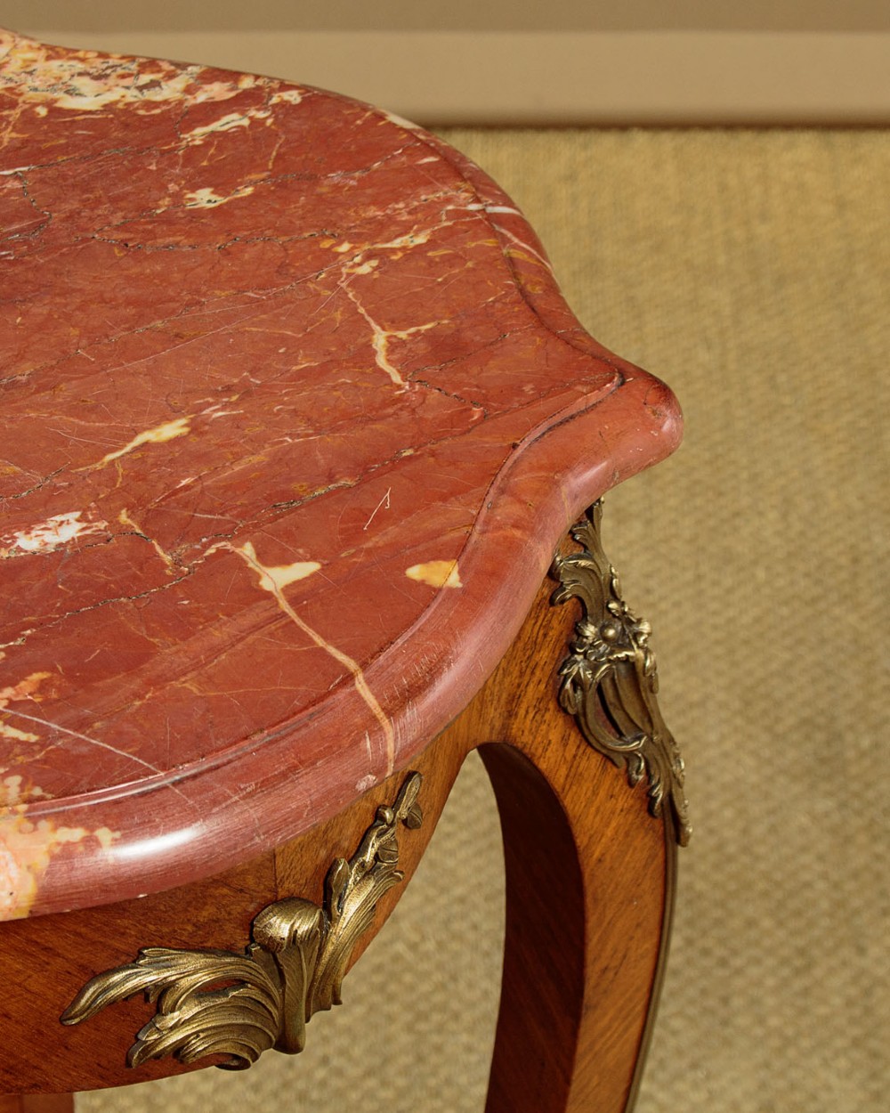 A French Louis XV style wine table with a contoured red marble top, parquetry veneer, metal mounts, and cabriole legs. View VIII