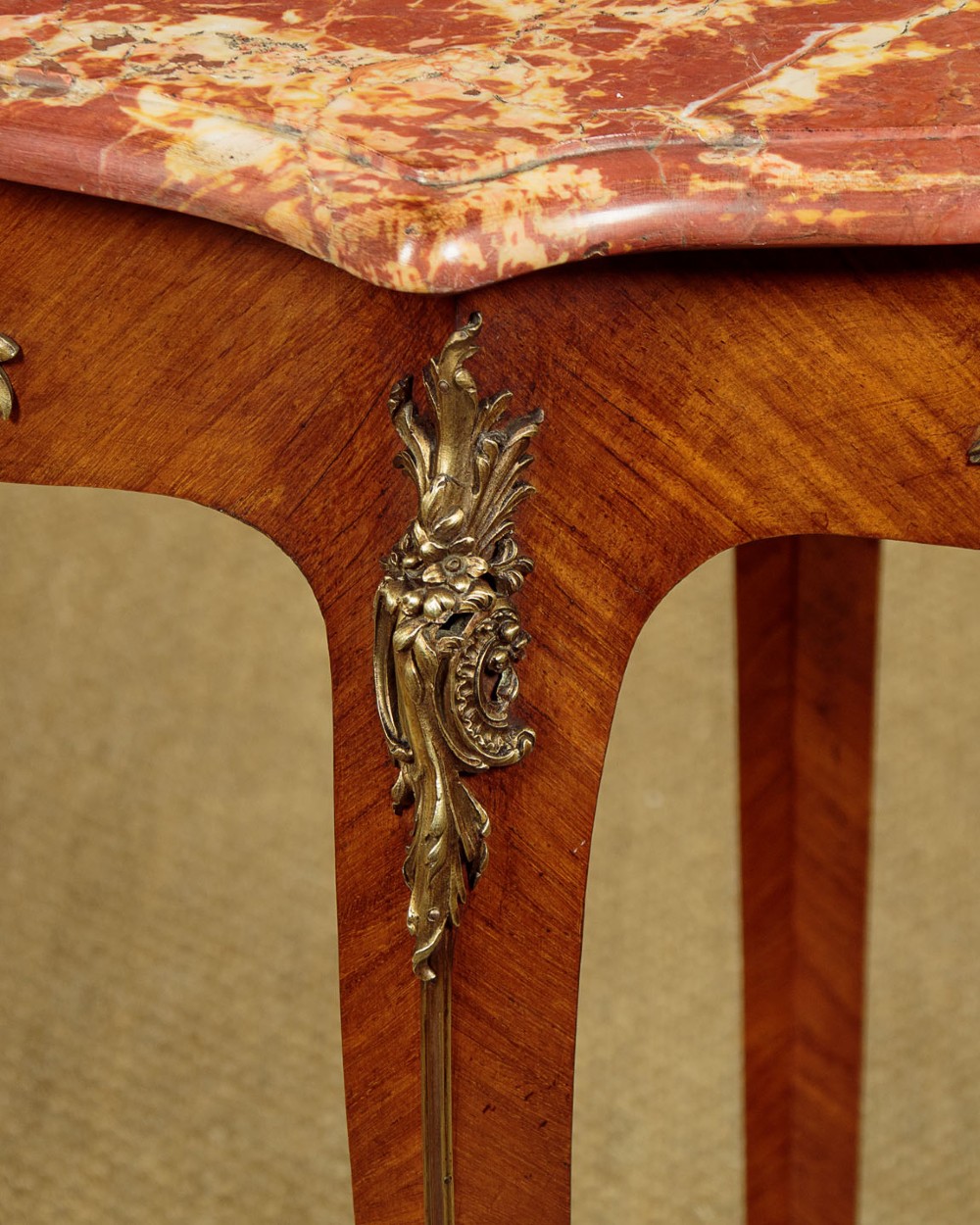 A French Louis XV style wine table with a contoured red marble top, parquetry veneer, metal mounts, and cabriole legs. View IX