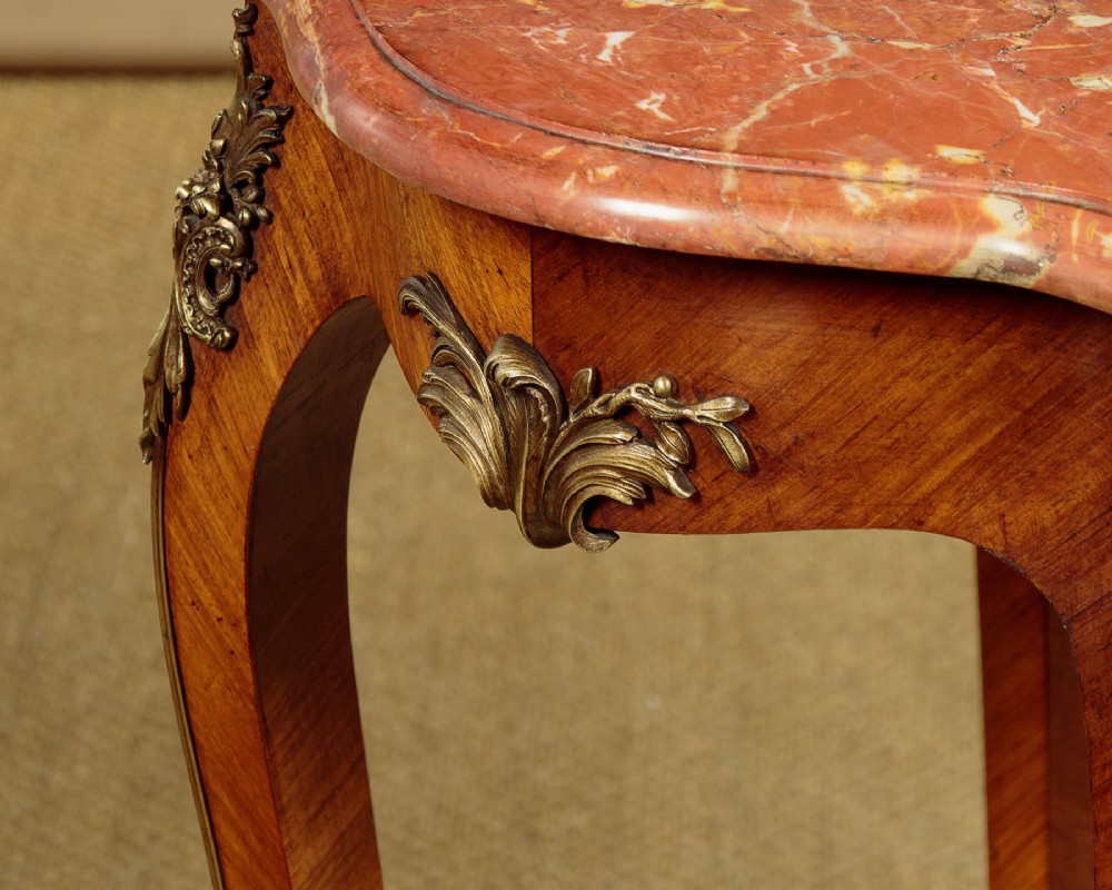A French Louis XV style wine table with a contoured red marble top, parquetry veneer, metal mounts, and cabriole legs. View X