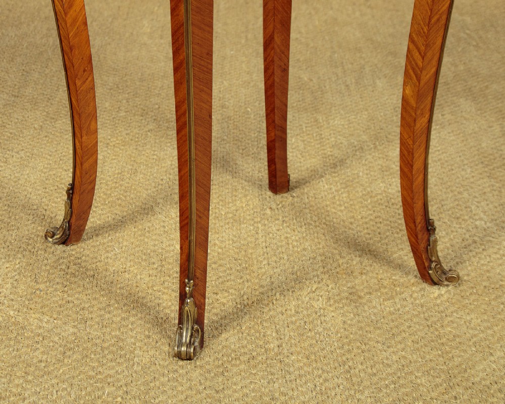 A French Louis XV style wine table with a contoured red marble top, parquetry veneer, metal mounts, and cabriole legs. View XII
