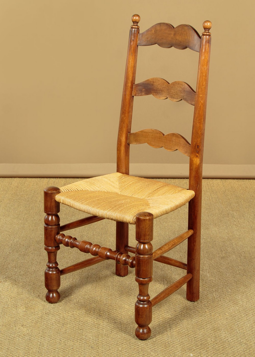 A set of six wooden ladderback dining chairs featuring wavy back slats, turned front legs, and woven rush seats. View II