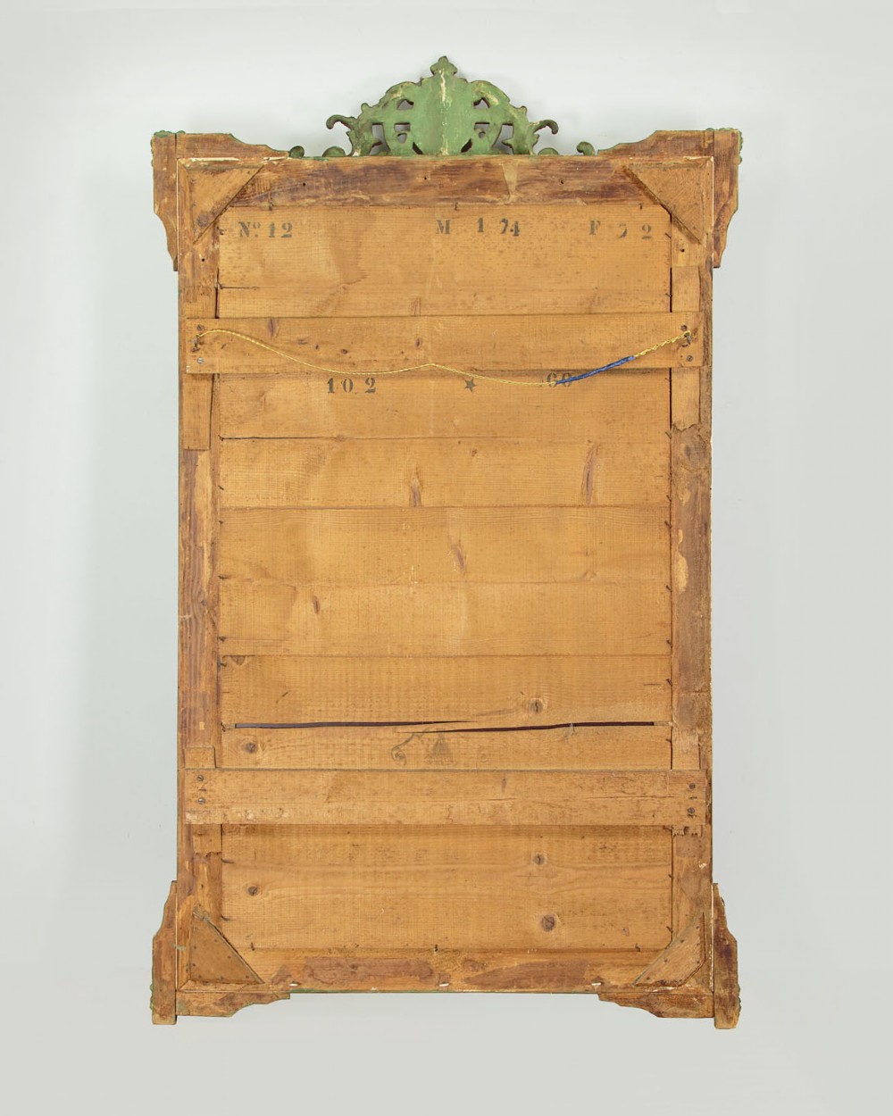 An antique rectangular French wall mirror featuring a gold gilded frame, ornate carved top cresting, and decorative floral mouldings. View X