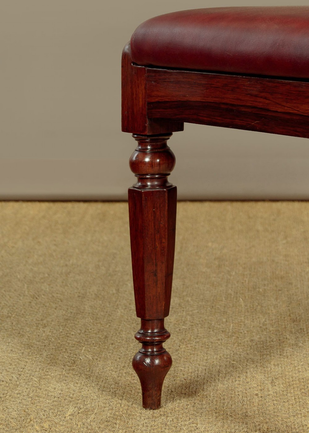 A set of four Regency rosewood dining chairs with carved scroll crest rails, turned front legs, and deep red leather drop-in seats. View XII
