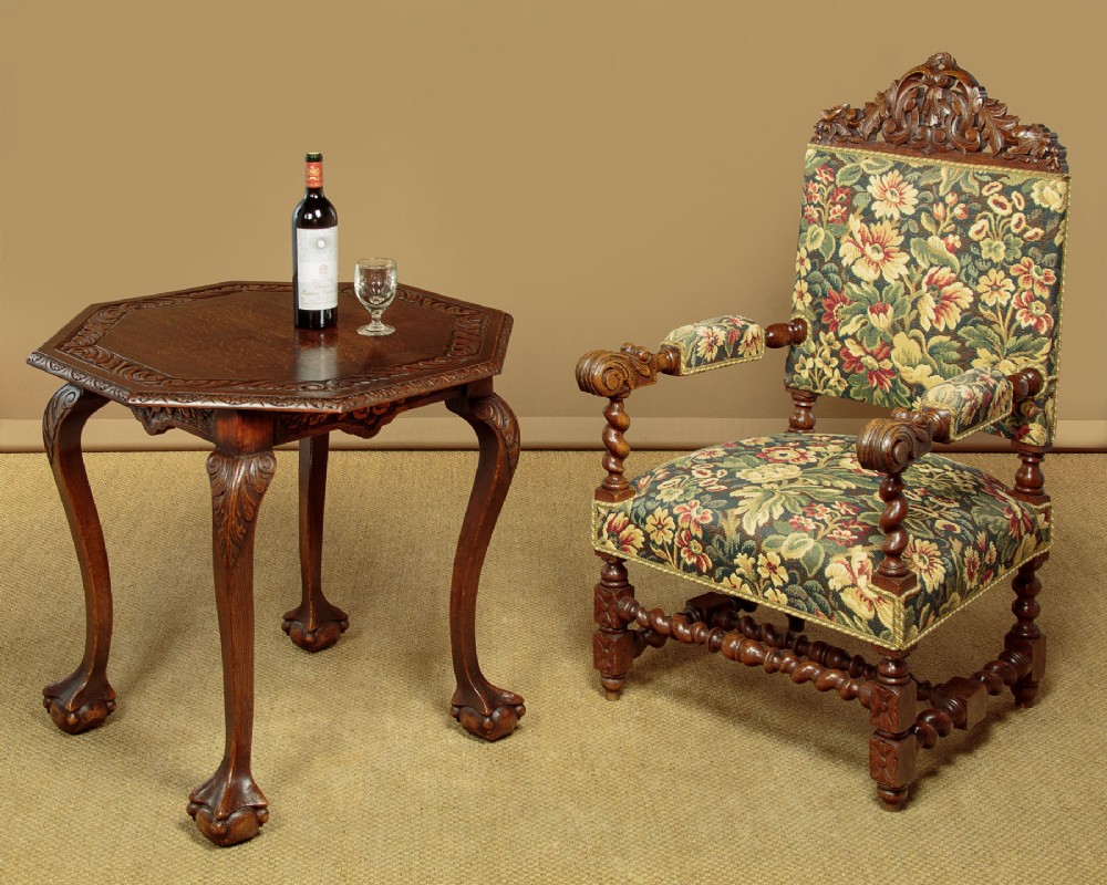 An octagonal dark carved oak side table featuring cabriole legs and carved ball and claw feet. View II