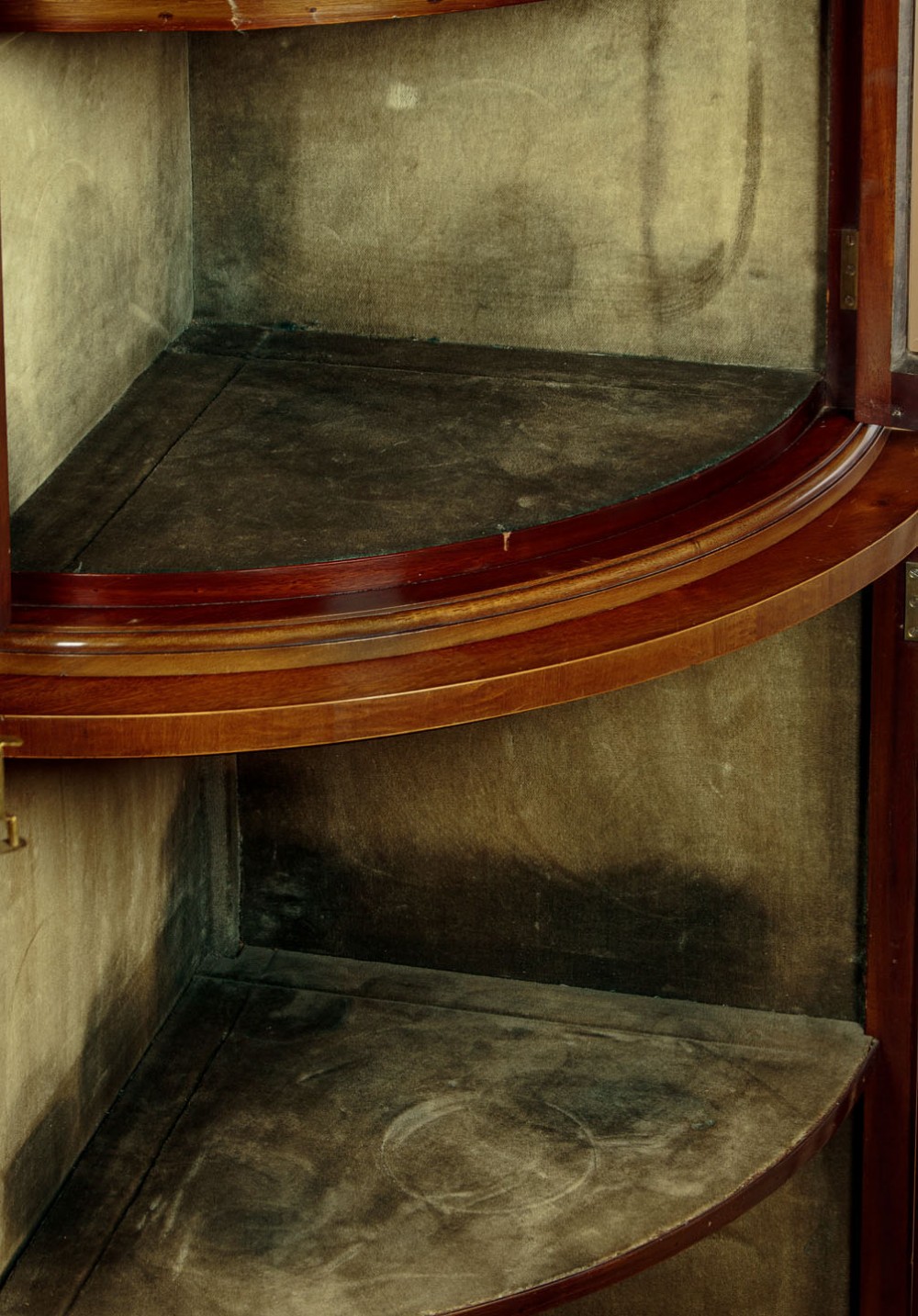 A two-tiered mahogany bow front corner display cabinet featuring upper gothic arch astragal glazing and lower glass panels. View XI