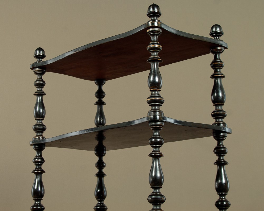 A tall mid-Victorian six-tier ebonised wood dumb waiter with turned spindle supports and finial caps. View VIII