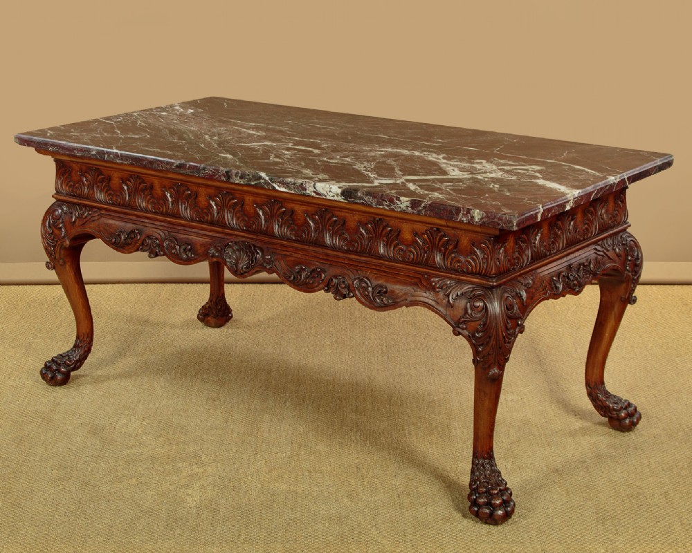 A George II style side table featuring a carved wooden frame with cabriole legs, ball and claw feet, and a polished dark marble top. View III